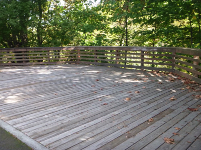 Large wooden viewing platform with railing